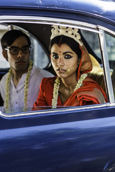 bengali bride and groom sitting in a blue ambassador car 