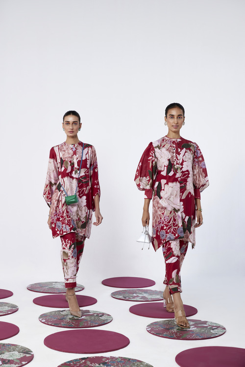 two models wearing ridhi mehra print collection in maroon and white 