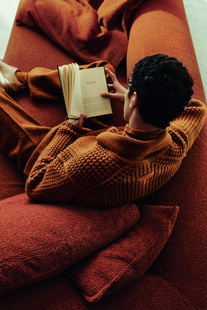 model wearing a Zegna cable knit sweater reading a book