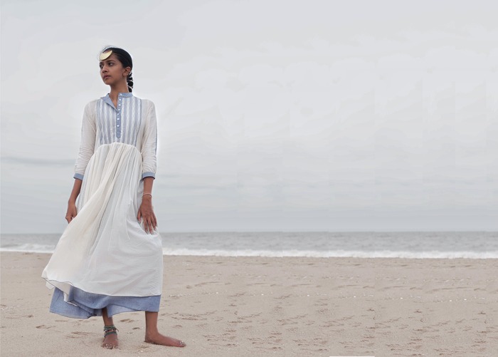 model wearing a white maxi dress on a beach by indian sustainable brand upsana 